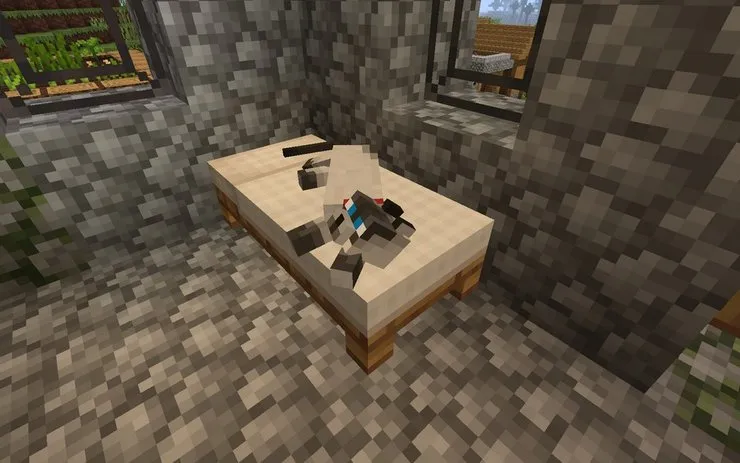 A cat laying on a player bed in Minecraft