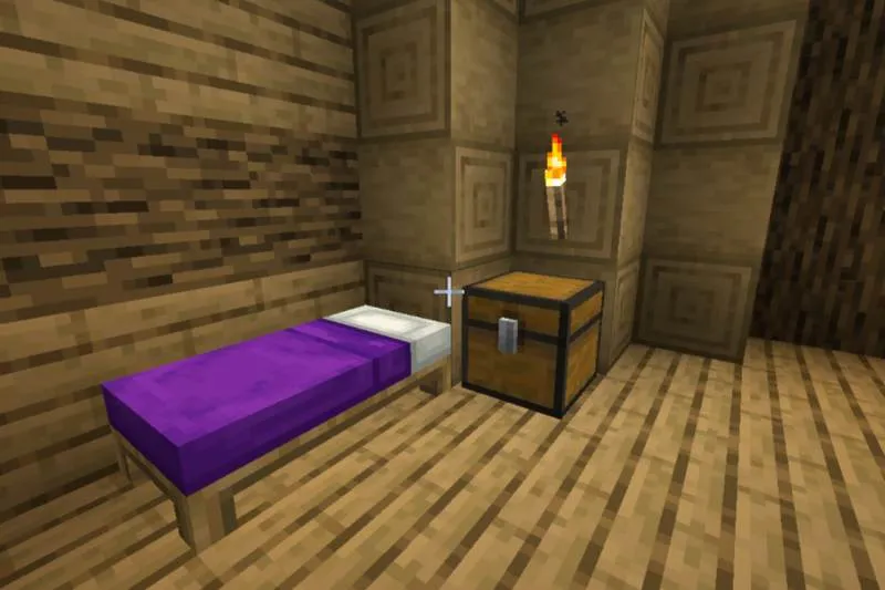 A chest sitting next to a bed inside a wooden room.