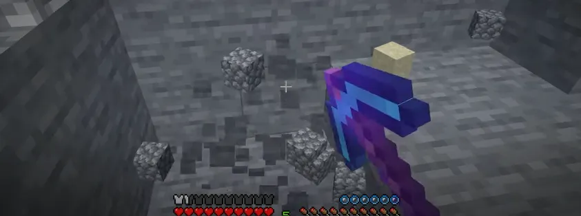 An image of a pickaxe mining underwater in Minecraft